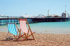 View of Brighton pier at dusk from the beach