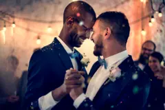 Two recently married gay men dancing at their wedding